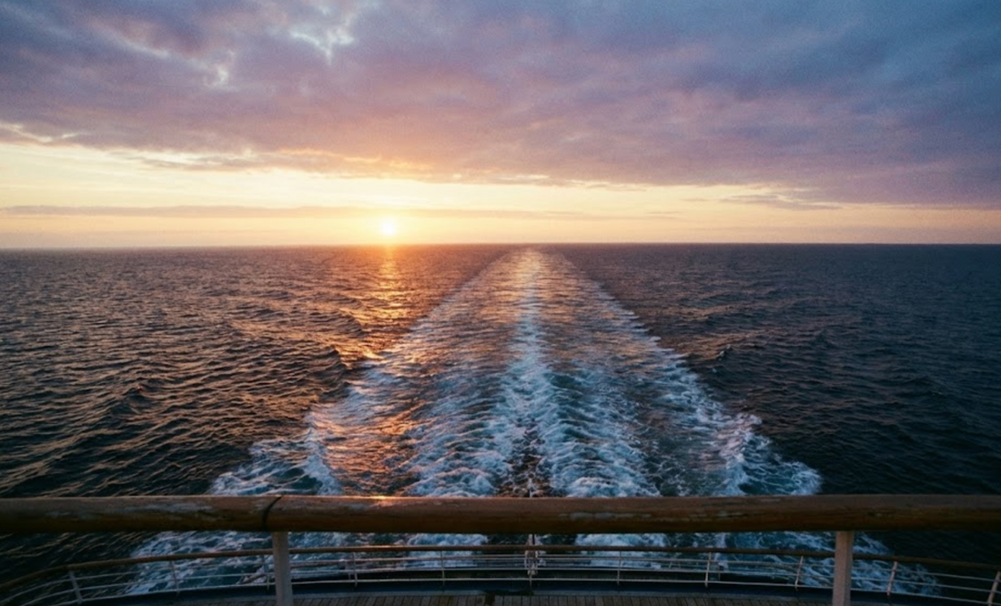 Calm ocean view from cruise ship deck at golden hour with biodegradable flower petals on water surface
