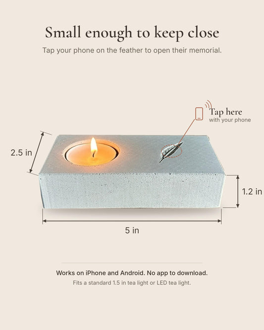 Memorial candle holder with an NFC chip hidden under the engraved feather, about 5 x 2.5 inches, with no printed QR code on its surface.